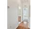 Hallway offers views to bathroom and a room with lots of light coming through the window at 31105 Whitlock Dr, Wesley Chapel, FL 33543