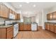 Well-lit kitchen with wood cabinets, granite countertops, and stainless steel appliances at 31105 Whitlock Dr, Wesley Chapel, FL 33543