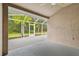 Lanai with a light concrete floor with a view of the backyard and a screen for insect prevention at 31105 Whitlock Dr, Wesley Chapel, FL 33543
