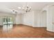 Open living space featuring wood floors, ceiling fan, sliding glass doors, and a chandelier at 31105 Whitlock Dr, Wesley Chapel, FL 33543