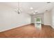 Spacious living room with wood floors, ceiling fan, and sliding glass doors at 31105 Whitlock Dr, Wesley Chapel, FL 33543
