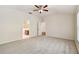 Spacious main bedroom with carpet, ceiling fan, and an en suite bathroom for added convenience at 31105 Whitlock Dr, Wesley Chapel, FL 33543