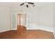 Well-lit office with French doors and wood-look floors. A ceiling fan provides additional comfort at 31105 Whitlock Dr, Wesley Chapel, FL 33543