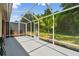 A screened-in patio with ample space overlooks the lush backyard, perfect for enjoying the outdoors while staying protected at 31105 Whitlock Dr, Wesley Chapel, FL 33543