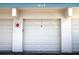 Garage doors with address number above, offers convenient parking and storage for vehicles and belongings at 3276 38Th S Way # D, St Petersburg, FL 33711