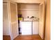 Laundry room tucked behind closet doors with washer, dryer and water heater at 3276 38Th S Way # D, St Petersburg, FL 33711