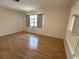 Bright living room with hardwood floors, a large window, and neutral walls at 3276 38Th S Way # D, St Petersburg, FL 33711