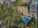 Aerial view of the home's backyard, featuring a pool and surrounding greenery, nestled amongst the trees at 330 Pineapple St, Tarpon Springs, FL 34689