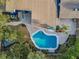 Aerial view of the pool in the backyard, with pavers, landscaping, lawn, and the home's roof at 330 Pineapple St, Tarpon Springs, FL 34689