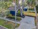 Birds-eye view of a blue home with mature trees, a wood fence and a brick driveway at 330 Pineapple St, Tarpon Springs, FL 34689