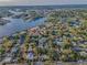 This aerial view shows the neighborhood is nestled among lush greenery and waterways at 330 Pineapple St, Tarpon Springs, FL 34689
