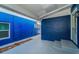 Back porch with painted blue walls, tile flooring, and access to yard at 330 Pineapple St, Tarpon Springs, FL 34689