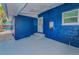 Back porch with painted blue walls, tile flooring, and new door at 330 Pineapple St, Tarpon Springs, FL 34689