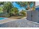 Beautiful backyard featuring a patio, pool and lush landscaping with mature trees and a storage shed at 330 Pineapple St, Tarpon Springs, FL 34689
