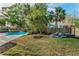 Spacious backyard featuring a pool, lush lawn, and landscaping materials, perfect for outdoor activities at 330 Pineapple St, Tarpon Springs, FL 34689