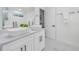 Modern bathroom features dual vessel sinks, white marble-look floors, and stylish black hardware at 330 Pineapple St, Tarpon Springs, FL 34689