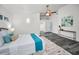 Bright bedroom boasts wood-look floors, a ceiling fan, and a large rug creating a modern and comfortable atmosphere at 330 Pineapple St, Tarpon Springs, FL 34689