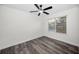 Bedroom featuring grey floors, white trim, ceiling fan and window at 330 Pineapple St, Tarpon Springs, FL 34689