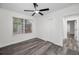 Bedroom featuring grey floors, white trim, window and closet at 330 Pineapple St, Tarpon Springs, FL 34689