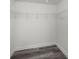 Walk-in closet with custom shelving and modern wood flooring at 330 Pineapple St, Tarpon Springs, FL 34689
