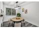 Cozy dining area with a round table, white cabinets, and natural light from a nearby window at 330 Pineapple St, Tarpon Springs, FL 34689