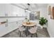 Charming dining area featuring white cabinets, a round table, and a window with natural light at 330 Pineapple St, Tarpon Springs, FL 34689