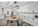 Bright dining area with white cabinets, a round table, and modern lighting at 330 Pineapple St, Tarpon Springs, FL 34689