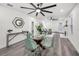 Bright dining room featuring views into the living room and kitchen, with gray wood flooring at 330 Pineapple St, Tarpon Springs, FL 34689
