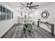 Dining area offering bright light, and views into the kitchen and living areas, with gray wood floors at 330 Pineapple St, Tarpon Springs, FL 34689
