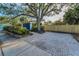 A blue home with a long paved driveway, partially shaded by a large tree, in a neighborhood at 330 Pineapple St, Tarpon Springs, FL 34689