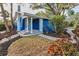 Charming blue home with a covered front porch and stone walkway, surrounded by lush landscaping at 330 Pineapple St, Tarpon Springs, FL 34689