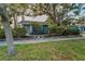 Charming front exterior features a blue facade, neat landscaping, and a welcoming pathway at 330 Pineapple St, Tarpon Springs, FL 34689