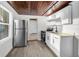 Kitchen with stainless steel appliances and white cabinetry at 330 Pineapple St, Tarpon Springs, FL 34689