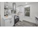 Modern kitchen with stainless steel appliances, white cabinets, quartz countertop, and large window for natural light at 330 Pineapple St, Tarpon Springs, FL 34689