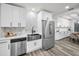Modern kitchen featuring white cabinets, stainless steel appliances, and a stylish backsplash at 330 Pineapple St, Tarpon Springs, FL 34689