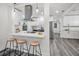 Bright, open-concept kitchen with breakfast bar, stainless steel range hood, and white cabinets at 330 Pineapple St, Tarpon Springs, FL 34689