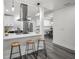 Open kitchen with a breakfast bar, stainless steel range hood, and views into the adjacent living spaces at 330 Pineapple St, Tarpon Springs, FL 34689