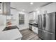 Well-lit kitchen showcasing stainless steel appliances, white cabinets, and modern countertops at 330 Pineapple St, Tarpon Springs, FL 34689