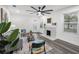 Inviting living room boasts lots of natural light, an oversized ceiling fan, and a decorative fireplace at 330 Pineapple St, Tarpon Springs, FL 34689
