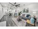 Beautifully designed living room features gray wood floors, leading into the modern kitchen at 330 Pineapple St, Tarpon Springs, FL 34689