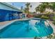 Inviting backyard pool with clear blue water, ladder, patio and chairs, and a surrounding privacy fence at 330 Pineapple St, Tarpon Springs, FL 34689