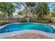 Beautiful backyard pool with clear blue water and surrounding privacy fence and landscaping at 330 Pineapple St, Tarpon Springs, FL 34689