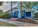 Two-story blue home with a white trim, well-maintained landscaping, and a cozy front porch at 330 Pineapple St, Tarpon Springs, FL 34689
