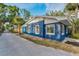 A quaint two-story blue home with white trim featuring well-maintained landscaping at 330 Pineapple St, Tarpon Springs, FL 34689