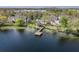 Stunning aerial view of homes along the water with a dock and gorgeous lake at 3429 Heards Ferry Dr, Tampa, FL 33618