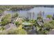 Aerial view of waterfront homes with a pool and dock overlooking a serene lake at 3429 Heards Ferry Dr, Tampa, FL 33618