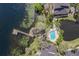 Aerial view of a community pool, pond and dock surrounded by lush greenery and waterfront homes at 3429 Heards Ferry Dr, Tampa, FL 33618