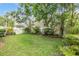 The backyard is completely enclosed by a white fence, with decorative green foliage along the border at 3429 Heards Ferry Dr, Tampa, FL 33618