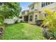 The fenced backyard is spacious, with a well-maintained lawn and tropical foliage surrounding the property at 3429 Heards Ferry Dr, Tampa, FL 33618