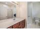 Bright bathroom with a large mirror, double vanity, and a separate area for the toilet at 3429 Heards Ferry Dr, Tampa, FL 33618